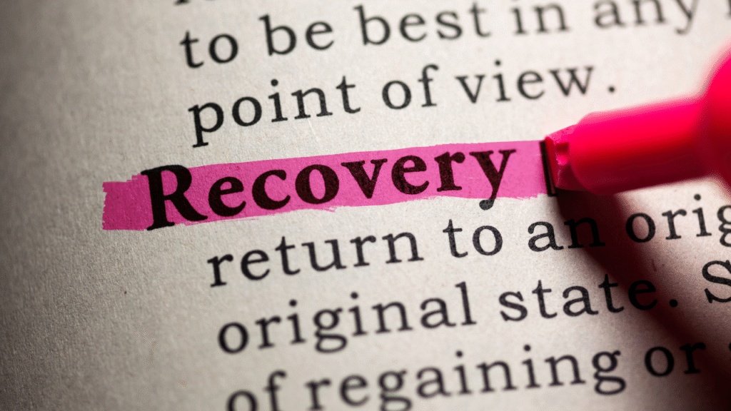 A close up of a book with the word "Recovery" highlighted in pink.