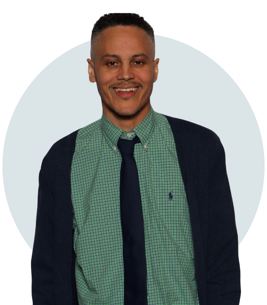 James Ian headshot - he stands looking directly at the camera smiling