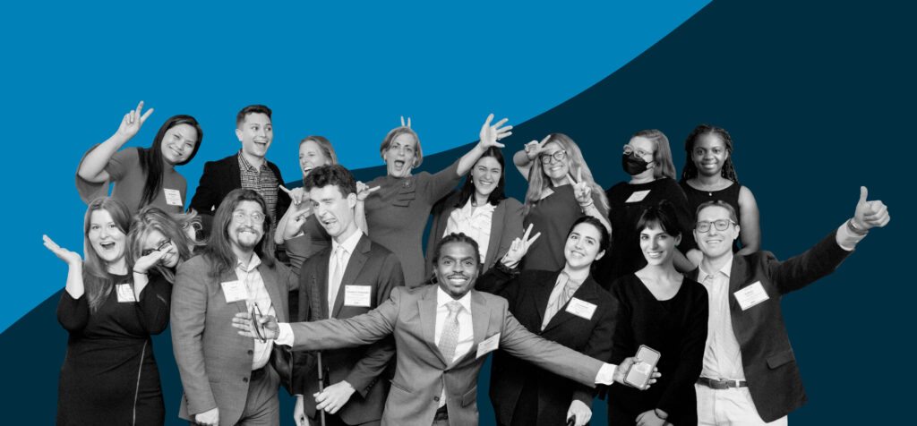 Black and white cutout image go the NOD staff smiling and making goofy faces with arms outstretched over a blue background.