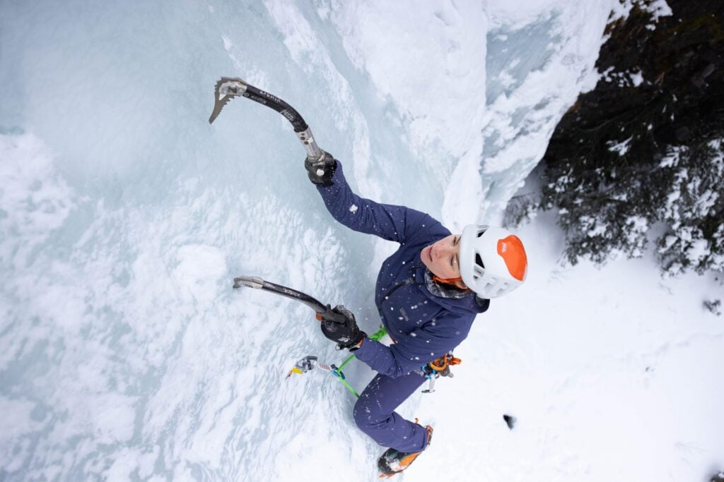 Kimber Cross using adaptive equipment to scale an ice mountain