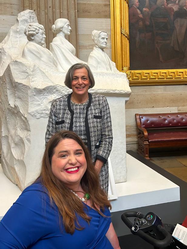 Beth Sirull, CEO and President of NOD stands behind Maria Town, President of AAPD. Both women are posing and smiling.