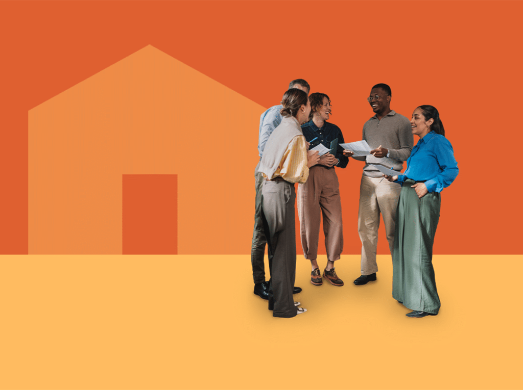 A group of professionals standing in a circle talking. In the background, a simple geometric graphic of a house over an orange background.