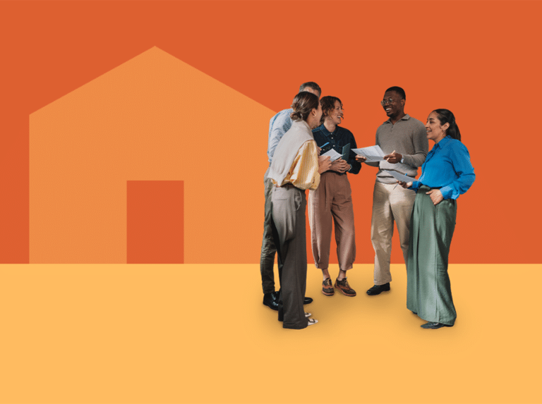 A group of professionals standing in a circle talking. In the background, a simple geometric graphic of a house over an orange background.