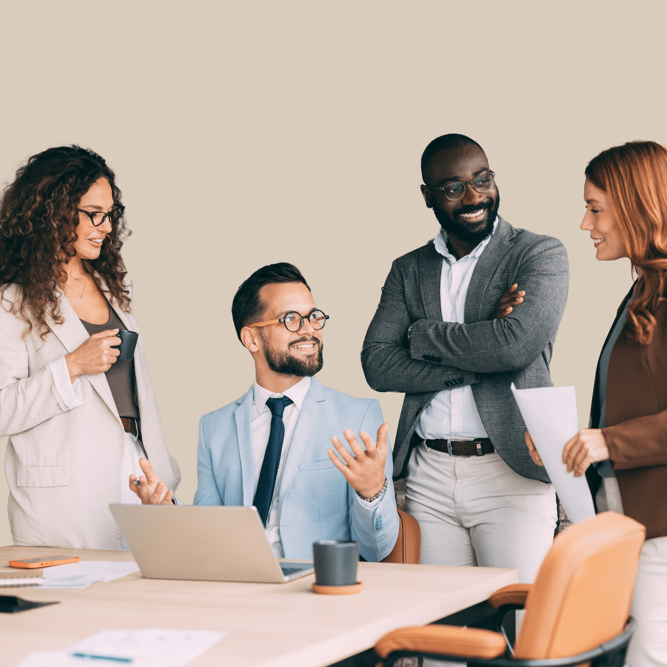 Four diverse business professionals gathered around a conference table, smiling and collaborating during a workplace meeting.