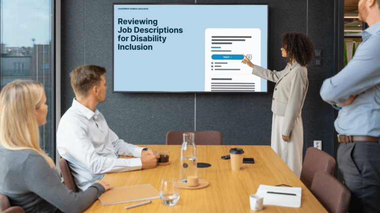4 people in a conference room, pointing at a screen with the resource cover on display
