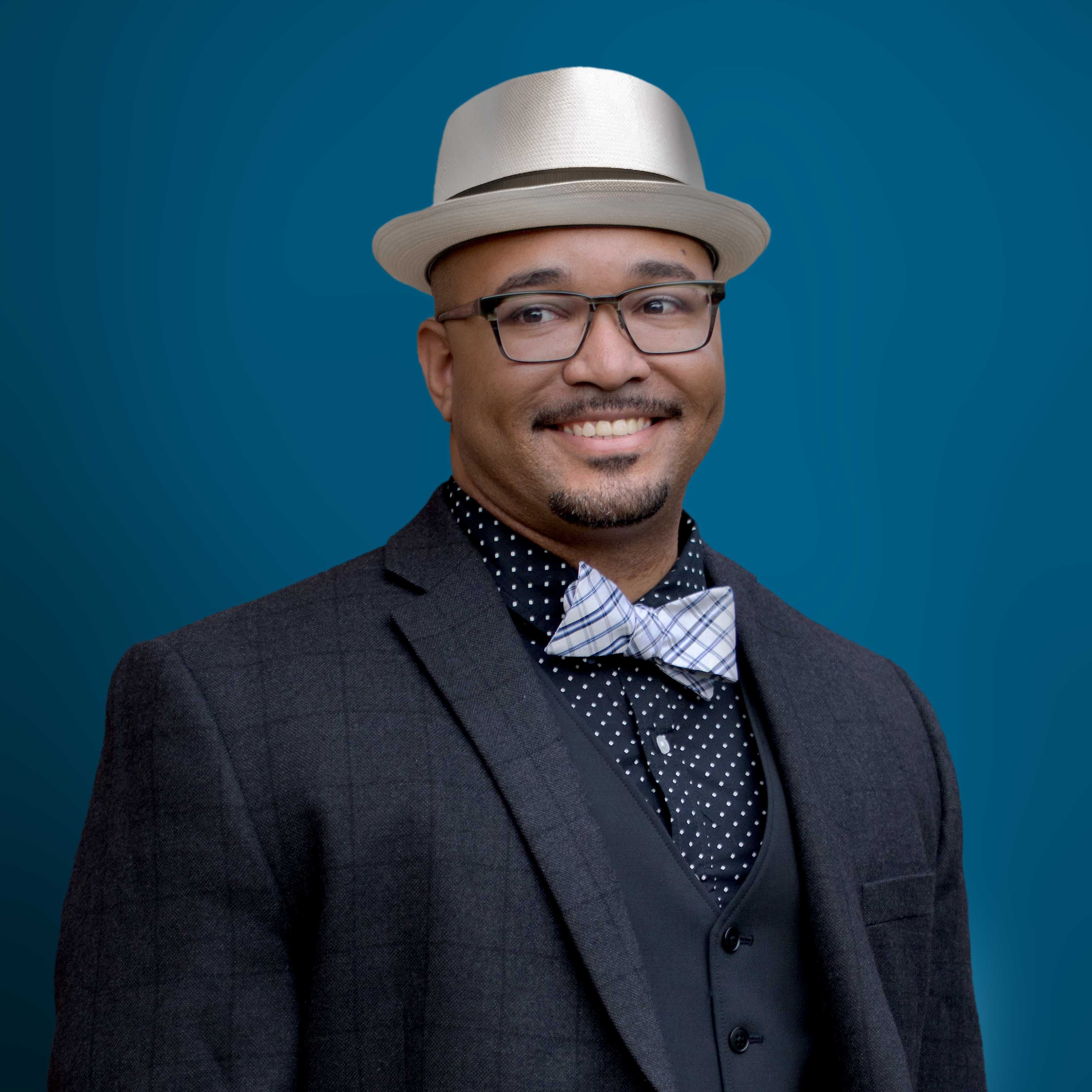 Headshot of Aaron Brown over a blue background