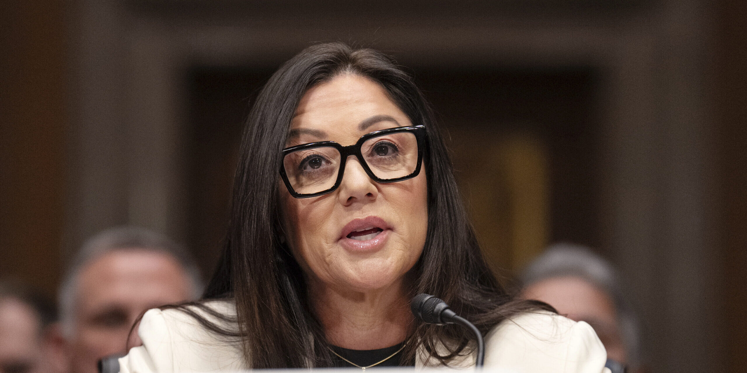 Lori Chavez-DeRemer seated at a table during a senate confirmation hearing