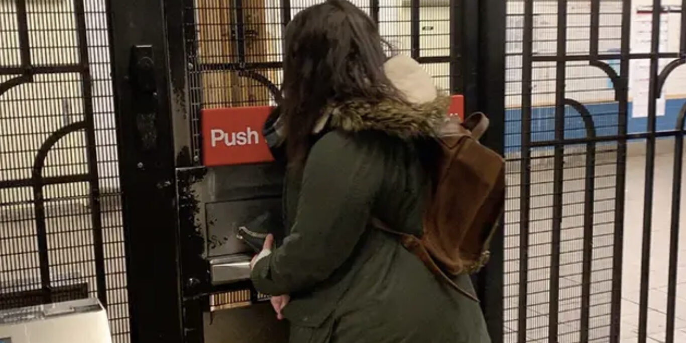 Woman opening emergency exit door in NYC subway station