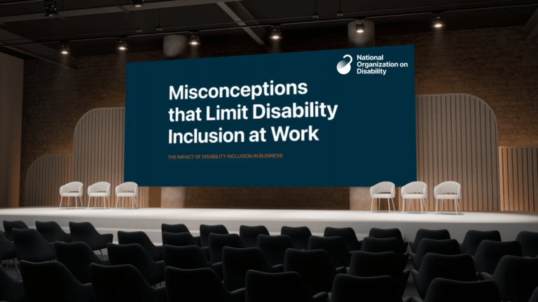 A big screen on a stage that reads "Misconceptions that Limit Disability Inclusion at Work"