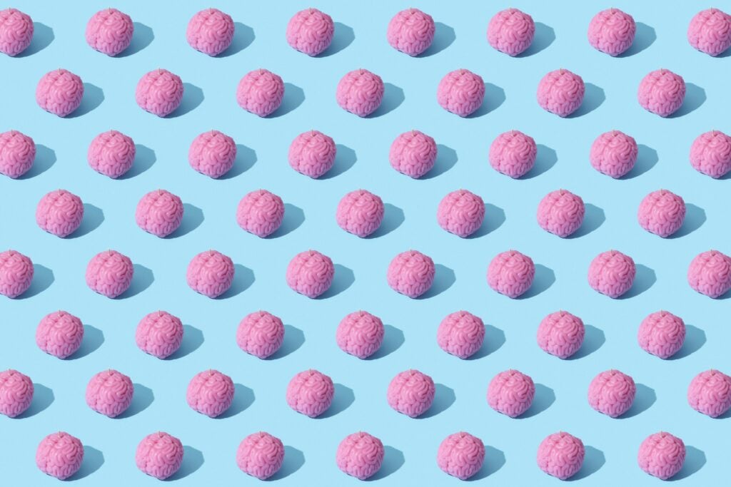 Many brains lined up against a blue background